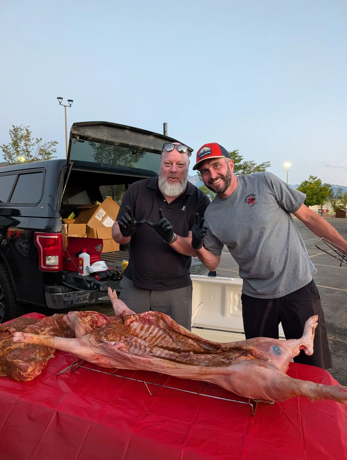 A whole roasted pig on the serving table with the crew behind it