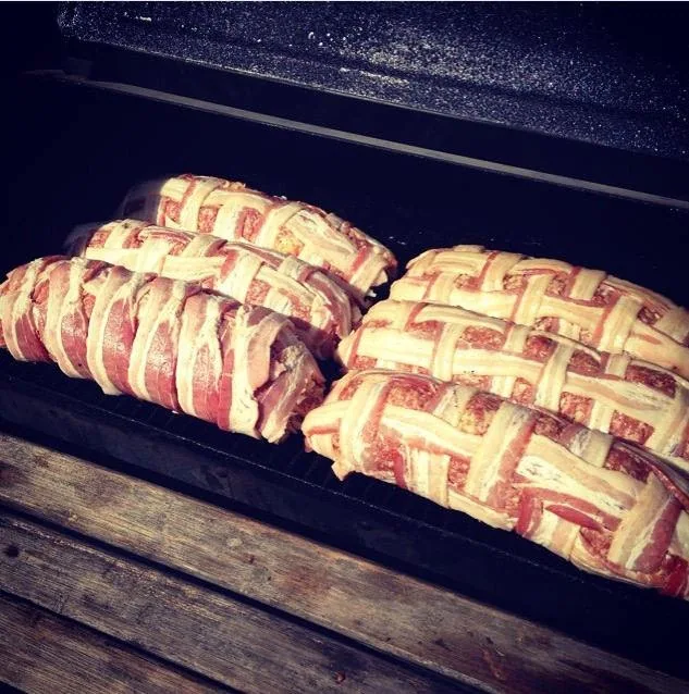 Four bacon-weave explosions resting on a tray before going on the smoker