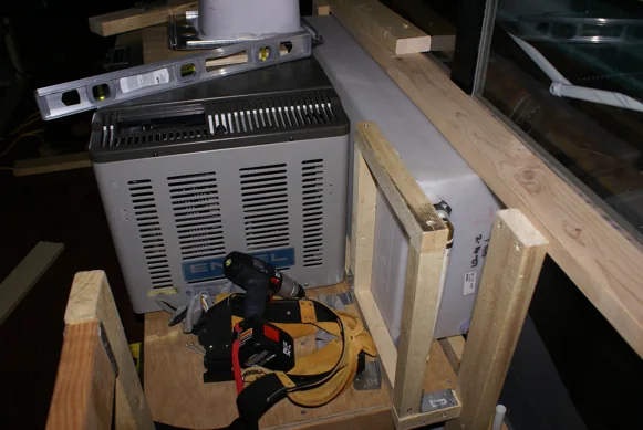 Bench and cabinet frames being built inside the stripped-out bus