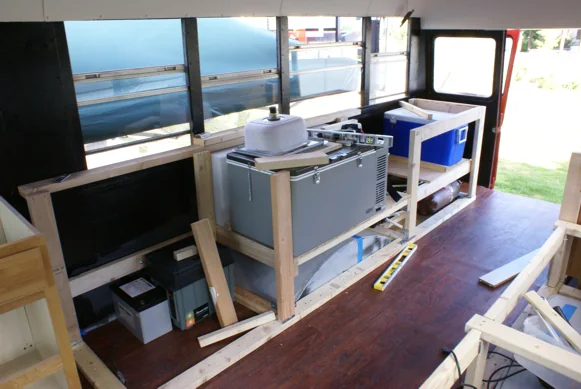 Galley framing inside the bus with the fridge, sink and cooler fitted