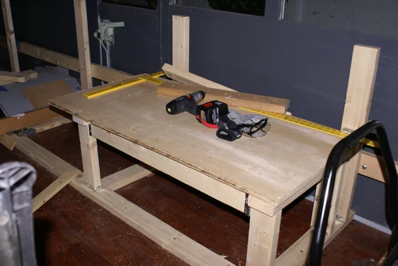 Bench and cabinet frames being built inside the stripped-out bus
