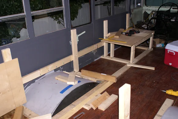 Bench and cabinet frames being built inside the stripped-out bus