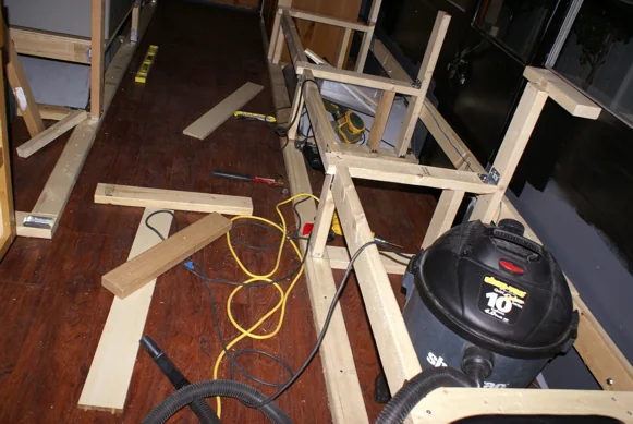 Bench and cabinet frames being built inside the stripped-out bus