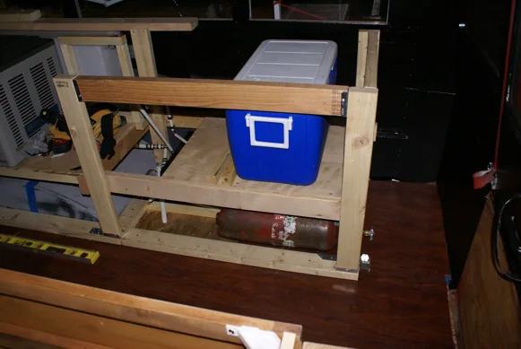 Bench and cabinet frames being built inside the stripped-out bus