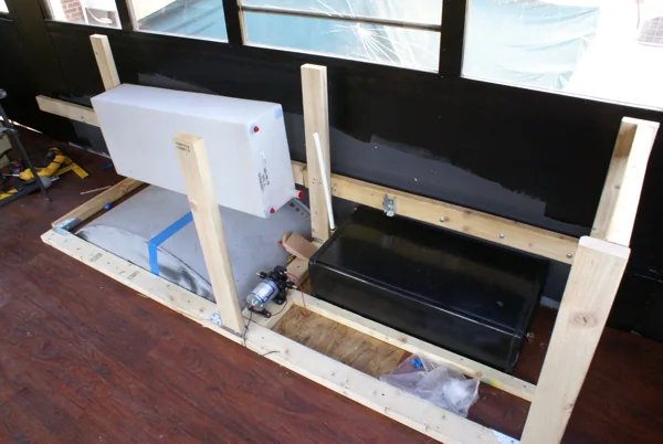 Galley framing inside the bus with the fridge, sink and cooler fitted