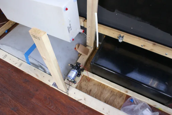 Galley framing inside the bus with the fridge, sink and cooler fitted