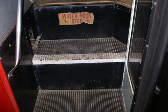 The bus entry steps with the old WATCH YOUR STEP sign