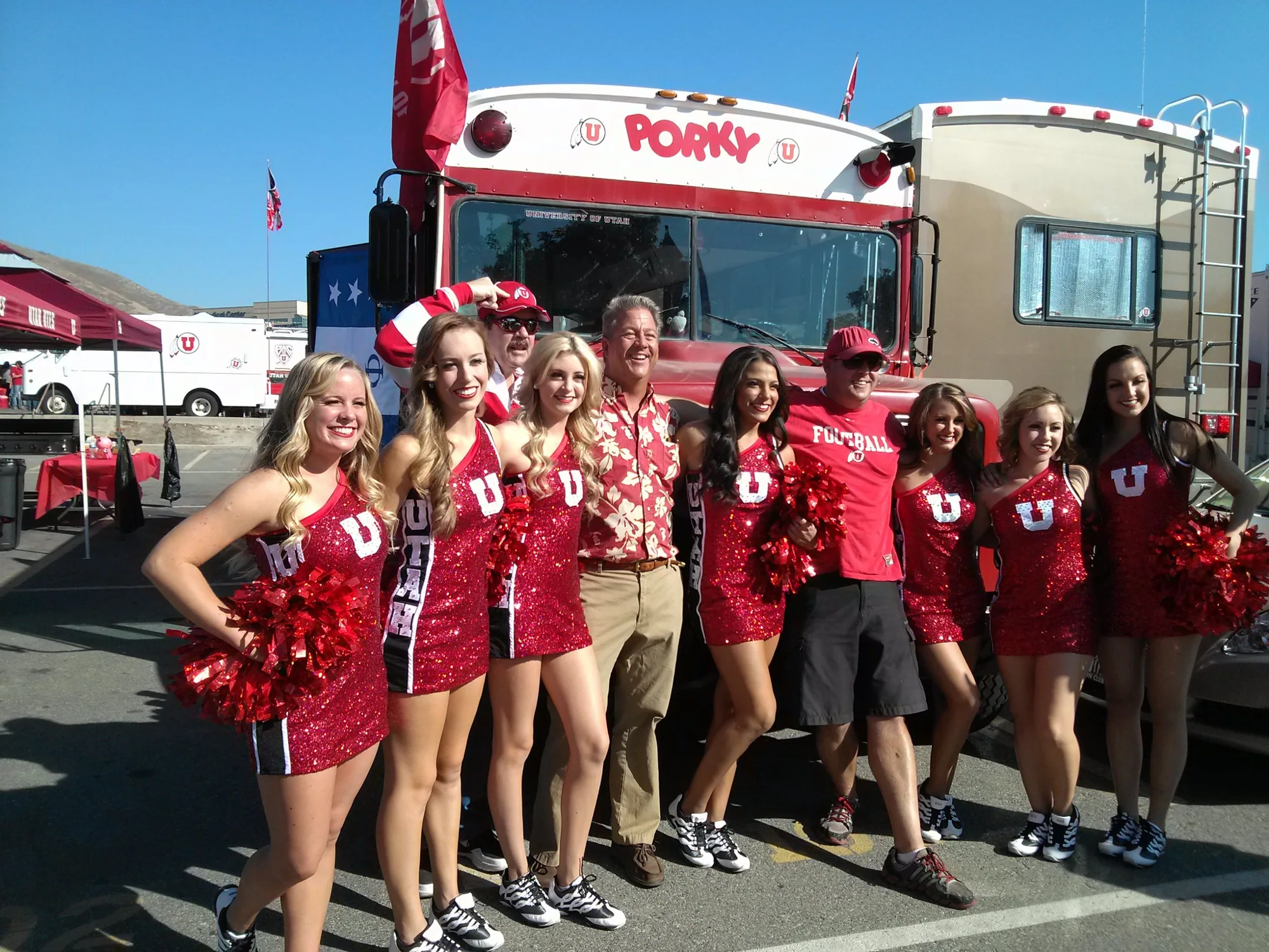 Cheerleaders and Pig Bus crew members lined up in front of the bus