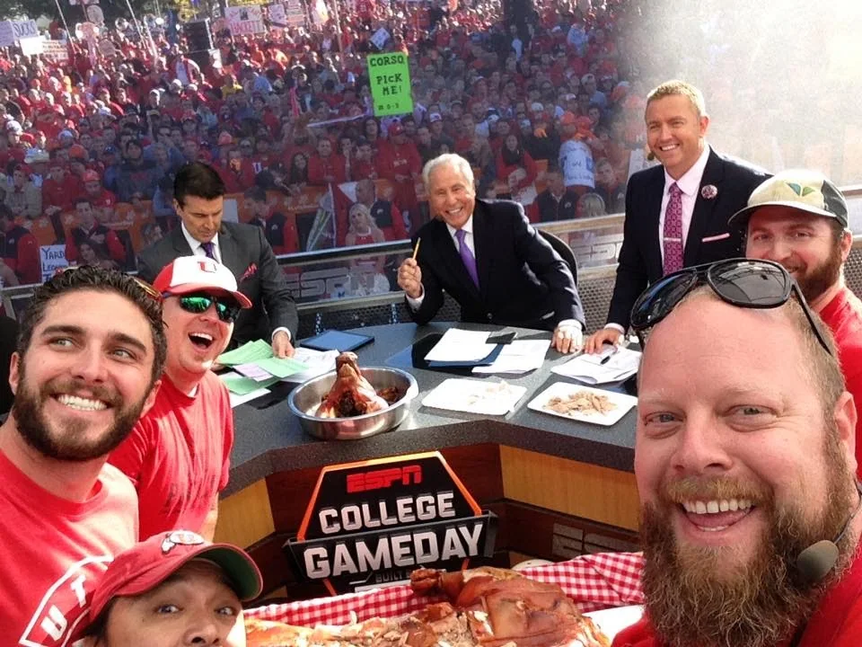 Pig Bus crew members photographed at the ESPN College GameDay set with food on the desk