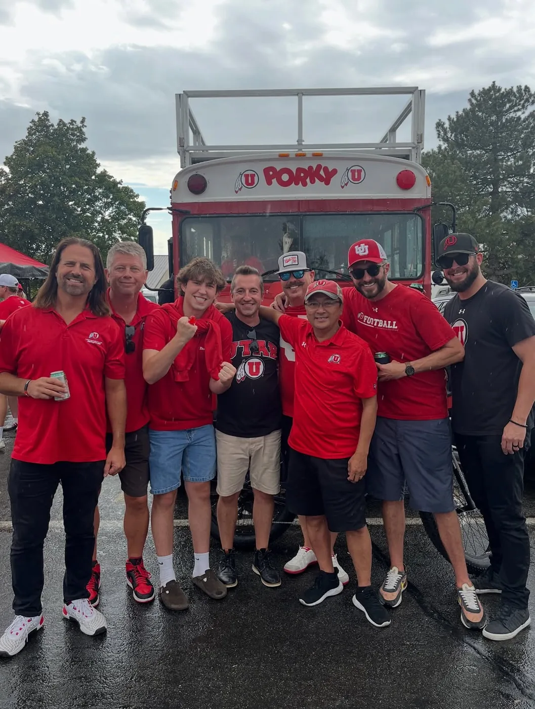 The Pig Bus crew in red shirts lined up in front of Porky on a game day