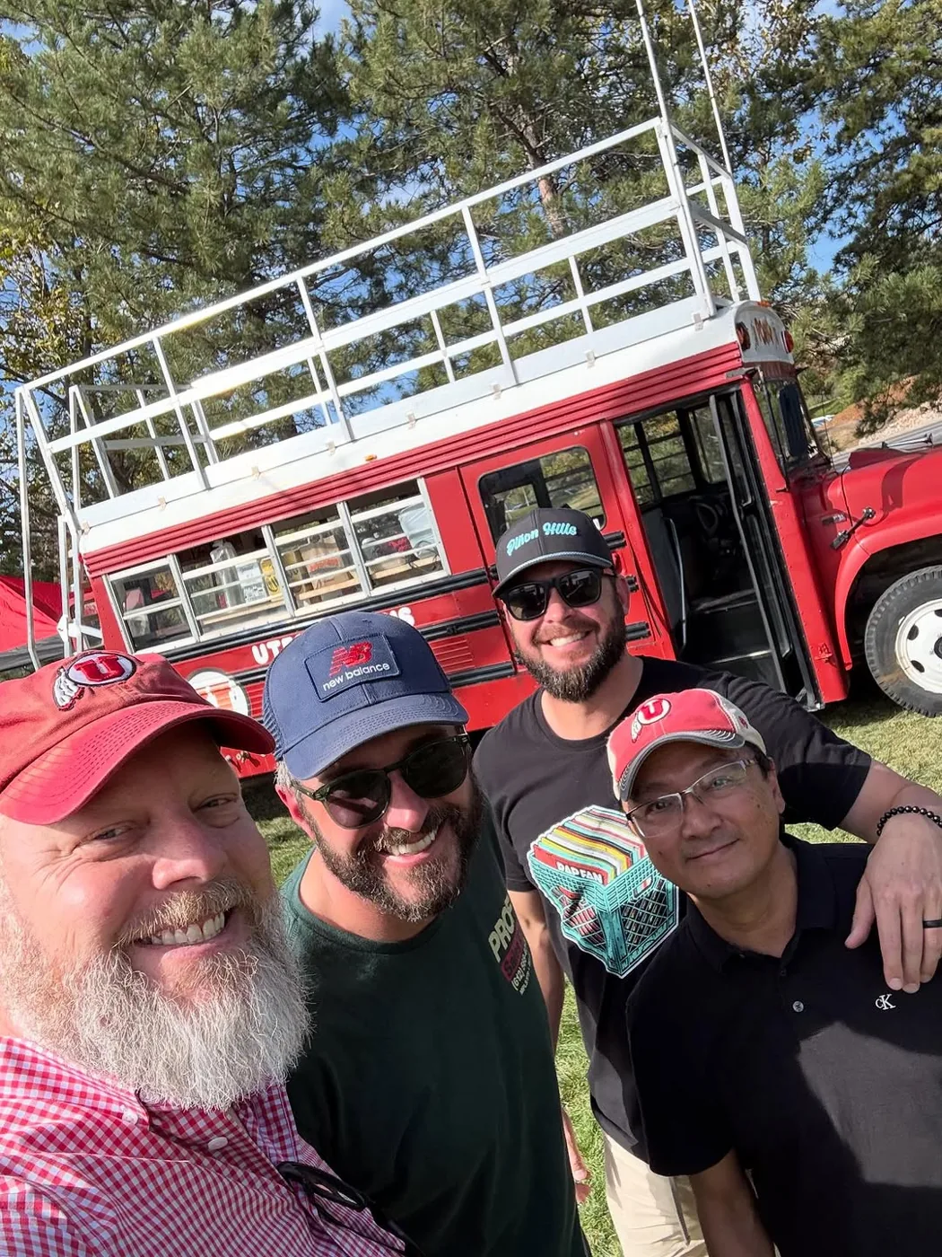 Four crew members taking a selfie in front of Porky with the roof deck behind them