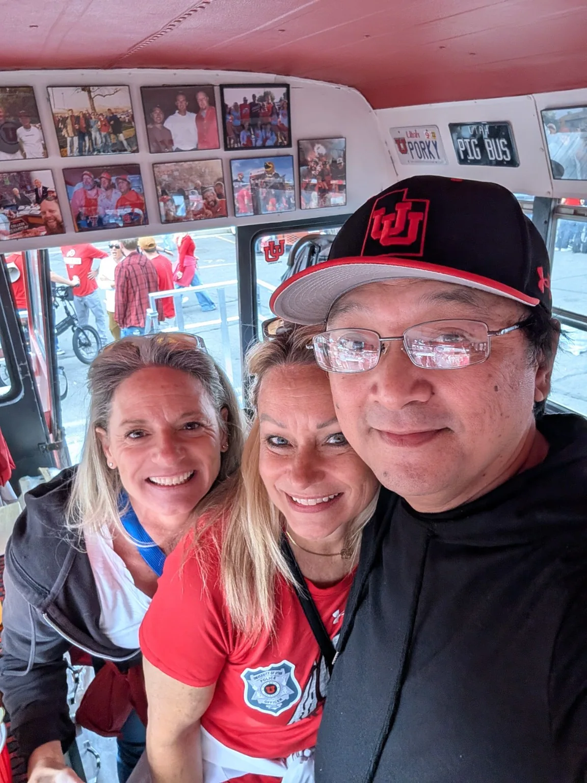 Guests inside the bus in front of the wall of photographs