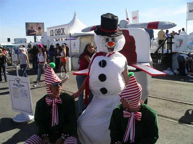 A crew member in a snowman costume with elves at Red Bull Flugtag