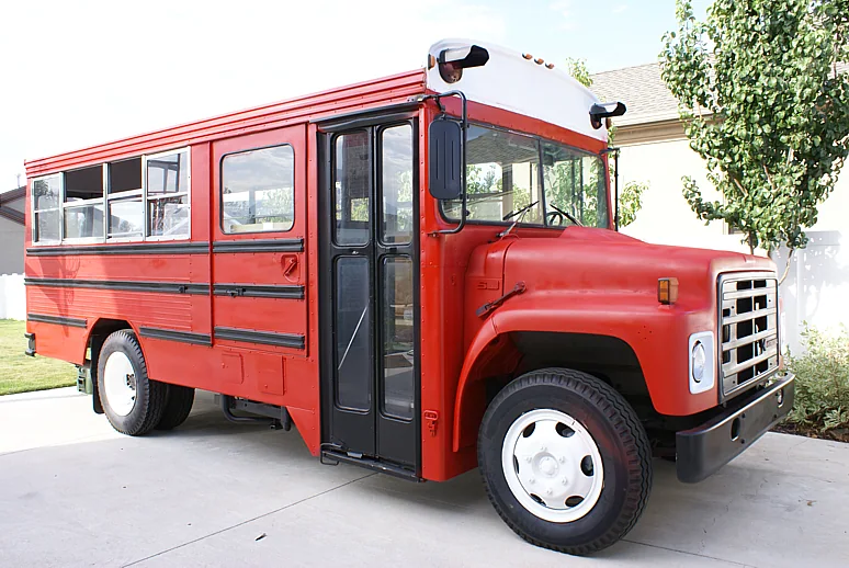 Side view of the Bluebird school bus after it was painted crimson