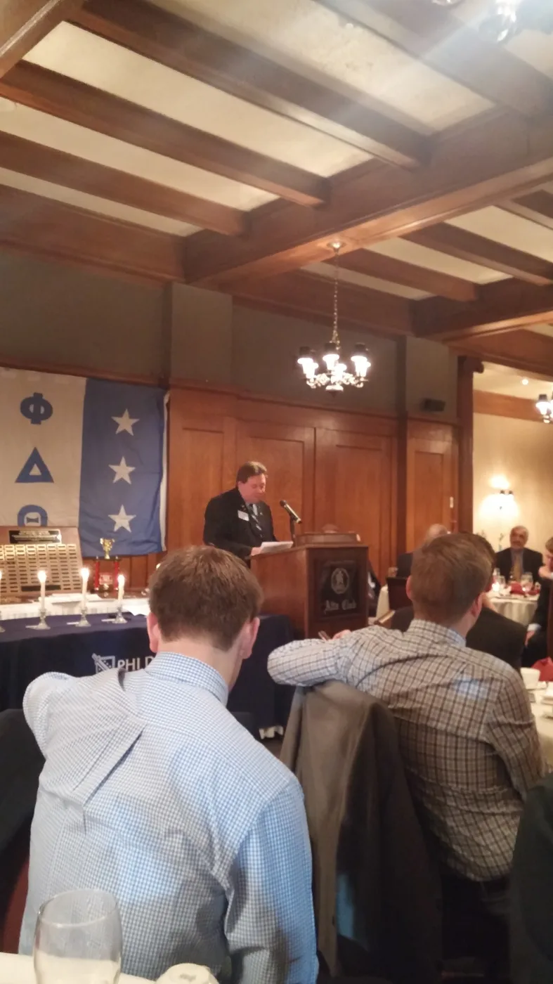 Brothers gathered in a wood-paneled hall at a Phi Delta Theta event