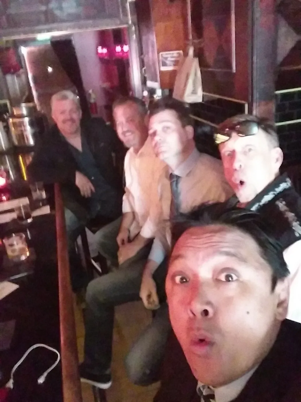 A selfie with brothers in a wood-paneled hall