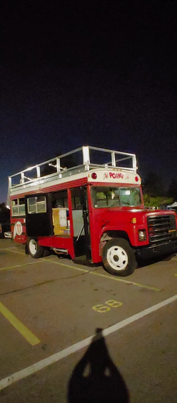 Porky at night with the side door open and the PORKY sign lit