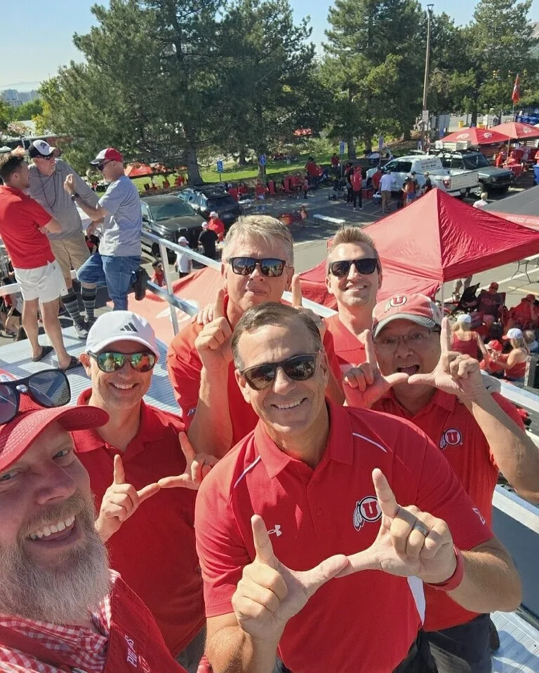 Crew members in red polos throwing the U on the roof deck