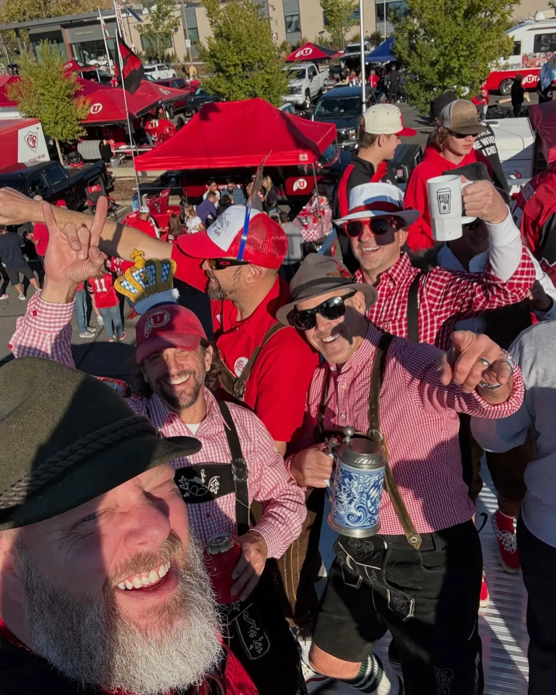 A selfie of the lederhosen crew raising steins on the roof deck