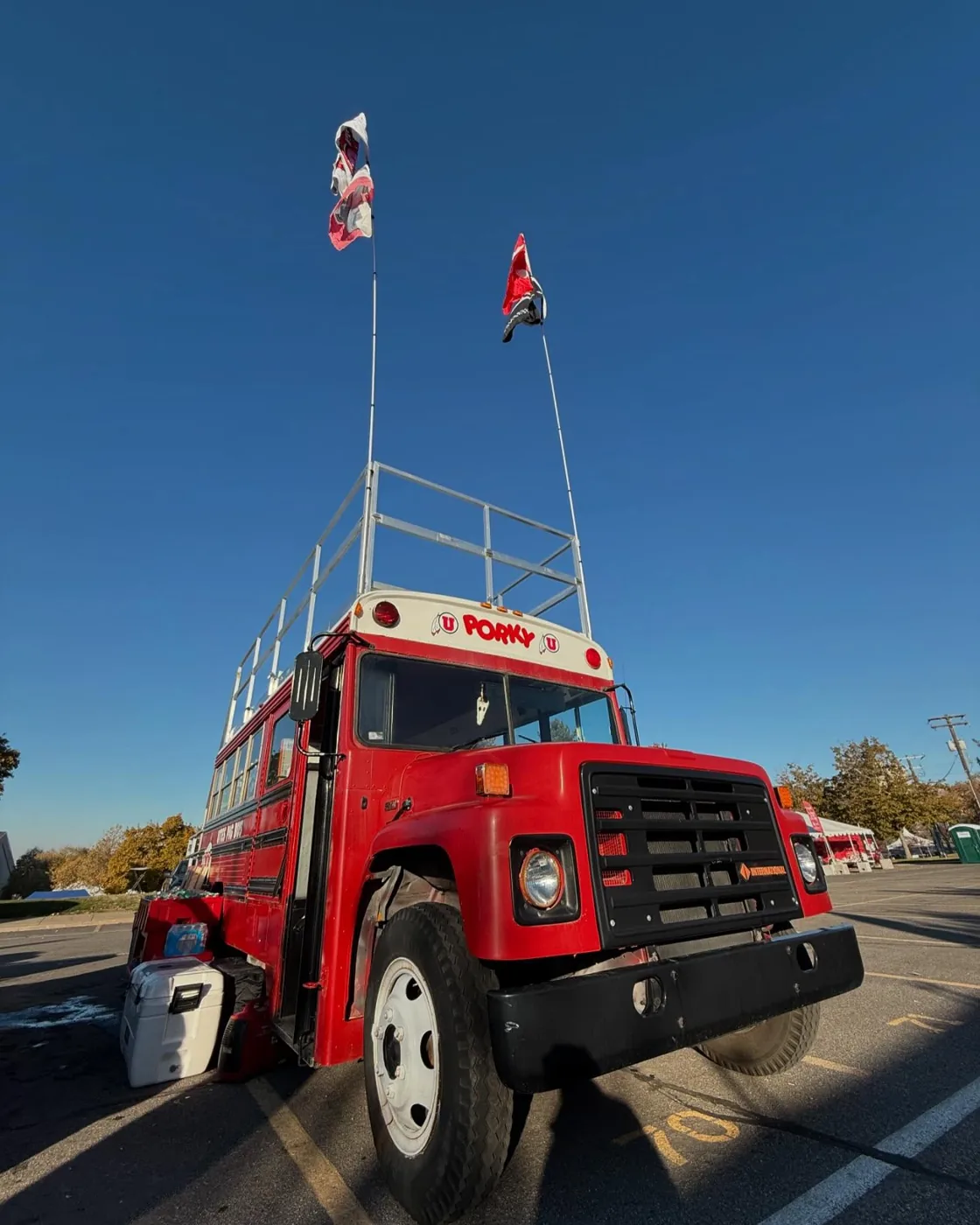 Porky from a low angle with flags flying high against a blue sky