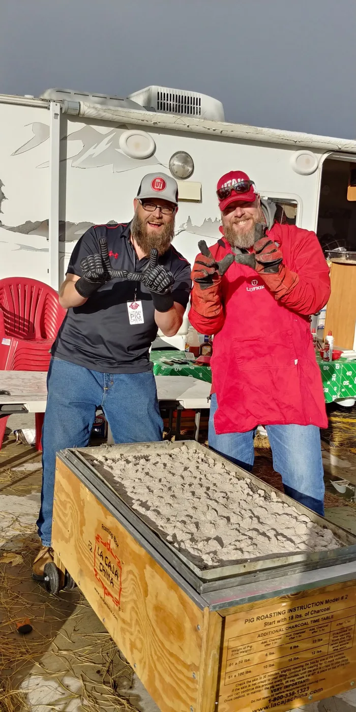 Two crew members in heat gloves throwing the U behind the roasting box
